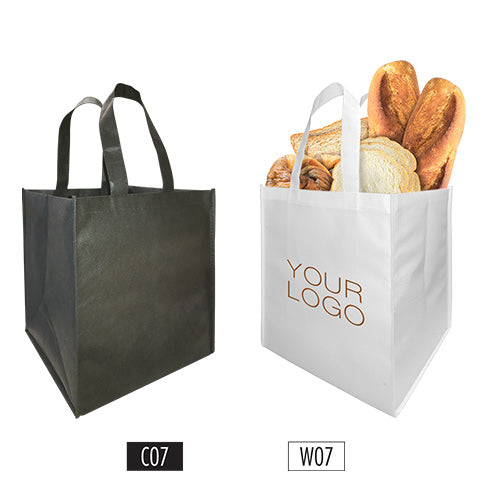 Two customized non-woven shopping bag with logo in black and white filled with breads