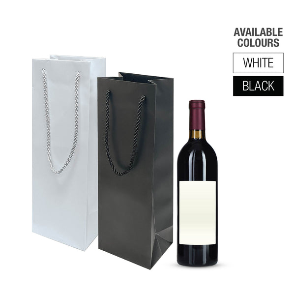 Two laminated paper bags with handles in white and black next to a wine bottle